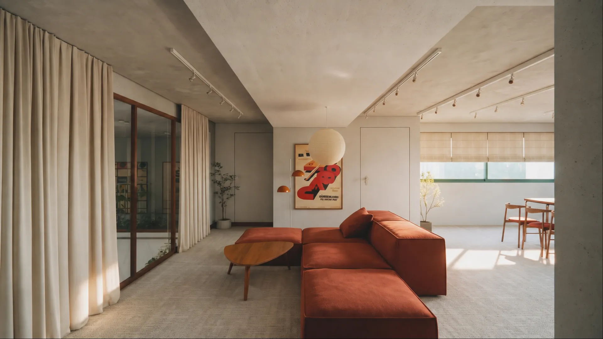 A breakout corner: rust sofa, round table and a framed print by the windows